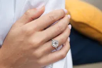 Lauren Round Halo and Sidestone engagement ring in 18kt yellow gold on the hand thumbnail 3