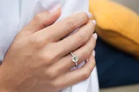 Veronica Six Claw Cathedral Solitaire and Sidestone engagement ring in 18kt yellow gold on the hand thumbnail 3