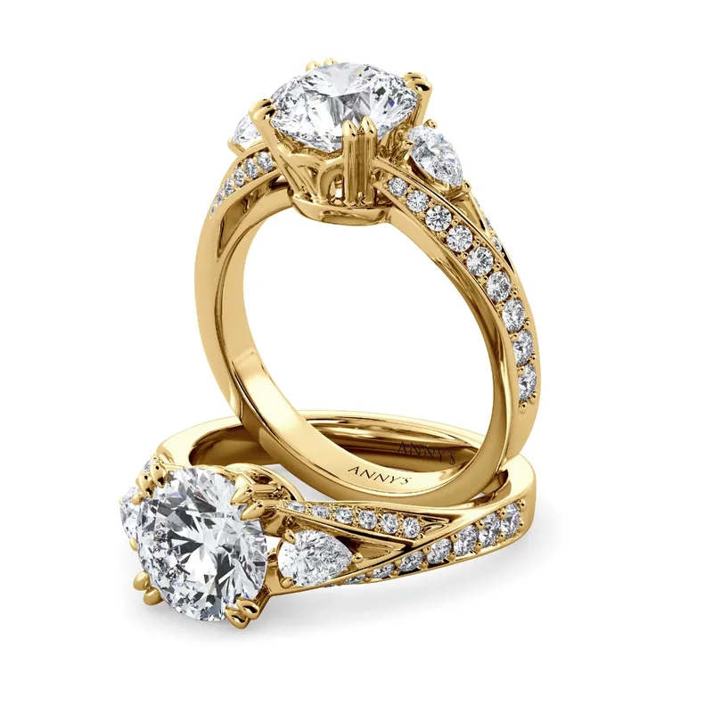 Roxy Pear Three Stone and Sidestone engagement ring with round centre in 18kt yellow gold